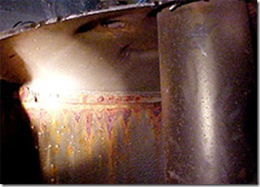 A view of the underside of this water heater shows it will soon spring a serious leak.